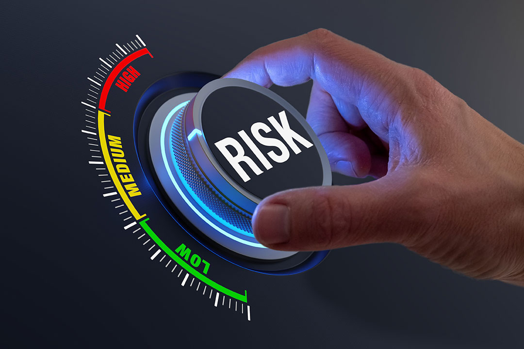 Risk management and mitigation to reduce exposure for financial investment, projects, engineering, businesses. Concept with manager's hand turning knob to low level. Reduction strategy.